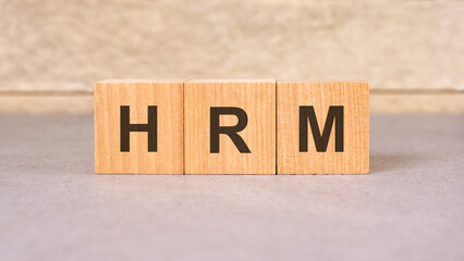 Poster - hrm acronym concept on cubes, gray background, selective focus