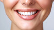 © Synaptic Studio - Dental care and hygiene concept. A close up photo of the lower part of a female face, handsome cute smile with very clean perfect teeth. White background.