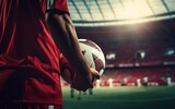 Fototapeta Sport - View back a soccer football player in red team concept, holding soccer ball in the stadium