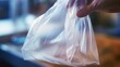 Detail of a plastic bag being open to extract recyclable contents.