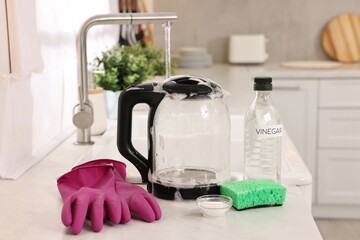 Poster - Cleaning electric kettle. Bottle of vinegar, sponge, rubber gloves and baking soda on countertop in kitchen