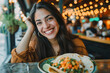 Happy Mexican woman smiling before eating delicious tacos in restaurant