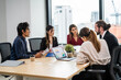 © Kawee - Group of multi-Ethnic businessman and businesswoman working in office.