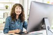 Asian young woman graphic designer smiling and looking at camera sitting at the desk with pc and tablet computer while working in office, Artist Creative Designer Illustrator Graphic Skill Concept
