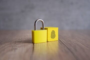 Wall Mural - padlock and wooden cube with fingerprint icon. copy space for text. biometric security concept.