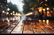 Wet empty dark brown wooden floor or table at middle of road. Raining and ground is wet. The trees and yellow lights are blurry in background. Realistic template pattern.	