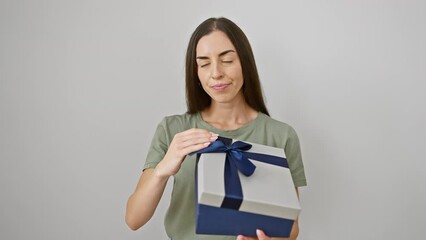 Sticker - Stressed young hispanic woman in white isolation, holding gift package - rage, surprise, frustration over birthday problem, wall of sadness and confused emotions