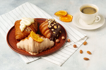 Wall Mural - Glazed croissants on clay plate on table