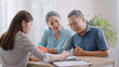 © Yingyaipumi - female realtor make property offer for sale to elderly spouses old customers contract on table,buy new home,take bank loan or medical health insurance concept.Financial advisor,realtor agent,insurance