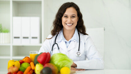 Wall Mural - Cheerful european woman dietitian working on diet plan.