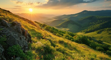 Sticker - Sunrise over lush green hills with light rays piercing through the valleys, highlighting the contours of the landscape.