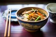 hot and sour soup with tofu and bamboo shoots, served in a traditional bowl