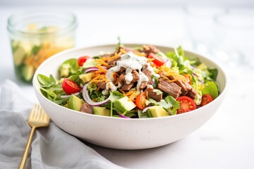 Wall Mural - beef taco salad in clear bowl with creamy dressing