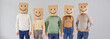 Portrait five casual male and female people with paper shopping package bags over heads with happy smiling emoticon mouth eyes facial expression drawn on them standing on gray color studio background