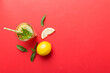 © sosiukin - Caipirinha, Mojito cocktail, vodka or soda drink with lime, mint and straw on table background. Refreshing beverage with mint and lime in glass top view flat lay