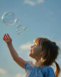 © Emir - Child blowing up the bubbles in the air in summer. Freedom concept artwork