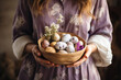 A peasant woman in a spring dress holds a patterned bowl of painted Easter eggs.