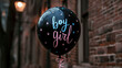 Black gender reveal confetti balloon with boy girl text in blue and pink, brick building background, gender reveal party, baby, pregnancy, baby shower