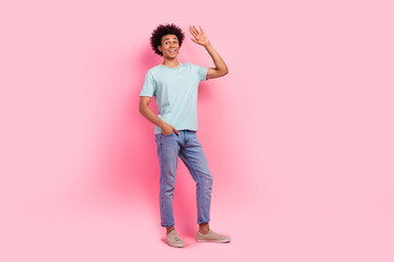 Poster - Full length photo of handsome young male waving hand cheerful greeting dressed stylish blue garment isolated on pink color background