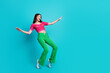 © deagreez - Full size photo of astonished girl wear pink top green trousers staring at impressive sale empty space isolated on blue color background