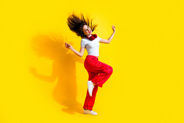 Wall Mural - Full length photo of dreamy excited lady wear white t-shirt earphones enjoying disco flying hair isolated yellow color background