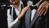 Fototapeta  - Concept dressmaker handmade couturier. Italy man tailor fitting bespoke suit to men in atelier or tailoring studio