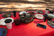 Festive outdoor picnic setup with seasonal decor and traditional food on a bright red tablecloth, embodying a cozy holiday spirit