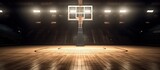 Fototapeta Sport - A basketball court with a ball in motion and stadium lights.