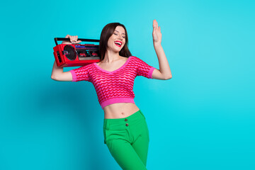 Canvas Print - Photo of positive cheerful girl dancing on discotheque enjoying sound music isolated blue color background