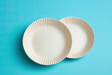 Sticker - Biodegradable paper dishes on a blue background, environmentally friendly.