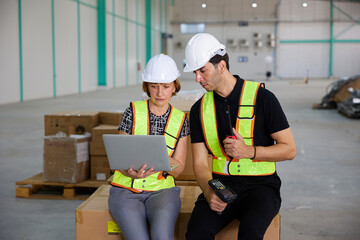 workers working on laptop computer in the warehouse storage