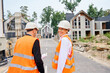 © Viacheslav Yakobchuk - Joyous construction manager and contractor inspecting development site