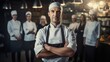 Portrait of a male chef standing with his team