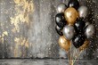 Black, golden and silver balloons and confetti on grunge wall background. Birthday, holiday or party background. Empty space for text. Festive greeting card.