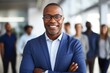 © Vorda Berge - Confident African American businessman with team in background
