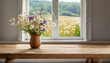 © Tatiana - An unoccupied wooden table adorned with a vase filled with wildflowers placed on the windowsill