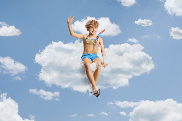 Sticker - Boy in swimming shorts and a diving mask sitting on a cloud