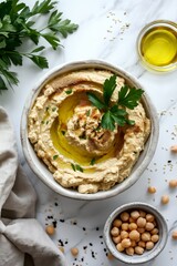 Wall Mural - Top view of traditional hummus from chickpea beans with oil in a bowl on white marble background