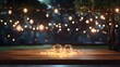 Empty Wood table top with decorative outdoor string lights hanging on tree in the garden at night time	