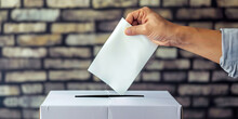 Hand Of Person Inserting Vote Into Ballot Box, Voting