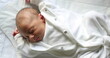 © Marco - Newborn baby asleep inside crib, first day of life of infant baby sleeping