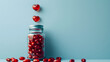 Red heart shaped pills in plastic bottle on the blue background. Concept of love and Valentine's Day