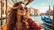 A girl in sunglasses and a sundress rides a gondola in Venice sun