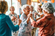 © VisualProduction - Smiley seniors dancing and having fun celebrating birthday in nu