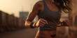 © Erzsbet - Close picture about a sporty style toned woman body who is jogging with smart watch and use other sport technology in sport top and short sunset or sunrise lights