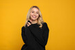 © New Africa - Happy woman in stylish warm sweater on orange background