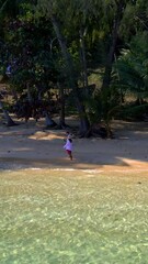 Wall Mural - Koh Wai Island Trat Thailand near Koh Chang. wooden bamboo hut bungalow on the beach and a young couple of men and women walking at the beach on a tropical Island in Thailand