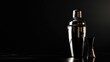 An elegant cocktail shaker and jigger on a dark reflective surface