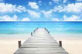 Fototapeta Do akwarium - Wooden pier on tropical beach with turquoise water and blue sky