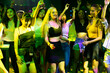 © NVB Stocker - Happy fun people drinking in night club. diverse young people dancing in night club. Nightlife and disco dance party concept. Fun music festival